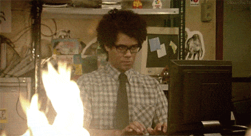 gif of man at computer typing watching a fire burn