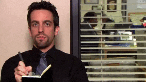 the office gif crossing off tasks in notebook
